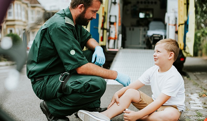 emt tending to a young boy