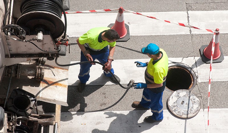 city workers by stereet manhole
